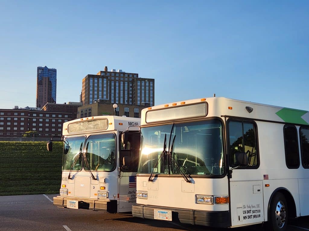 Two buses parked in urban setting