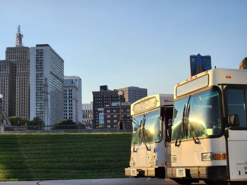 Buses in front of st. paul skyline. Contact elite party bus today for your next ride!
