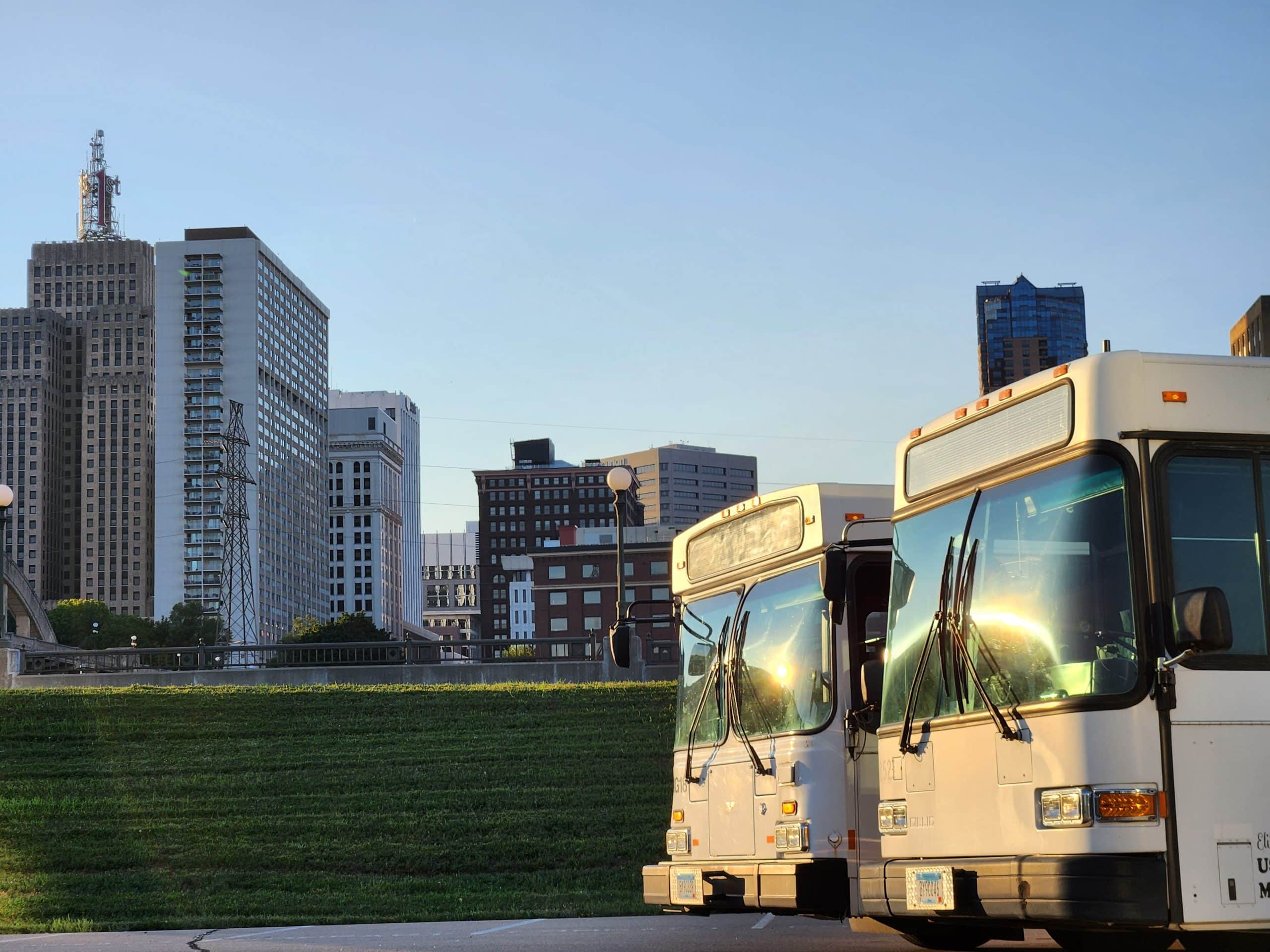 Buses in front of st. paul skyline. Contact elite party bus today for your next ride!