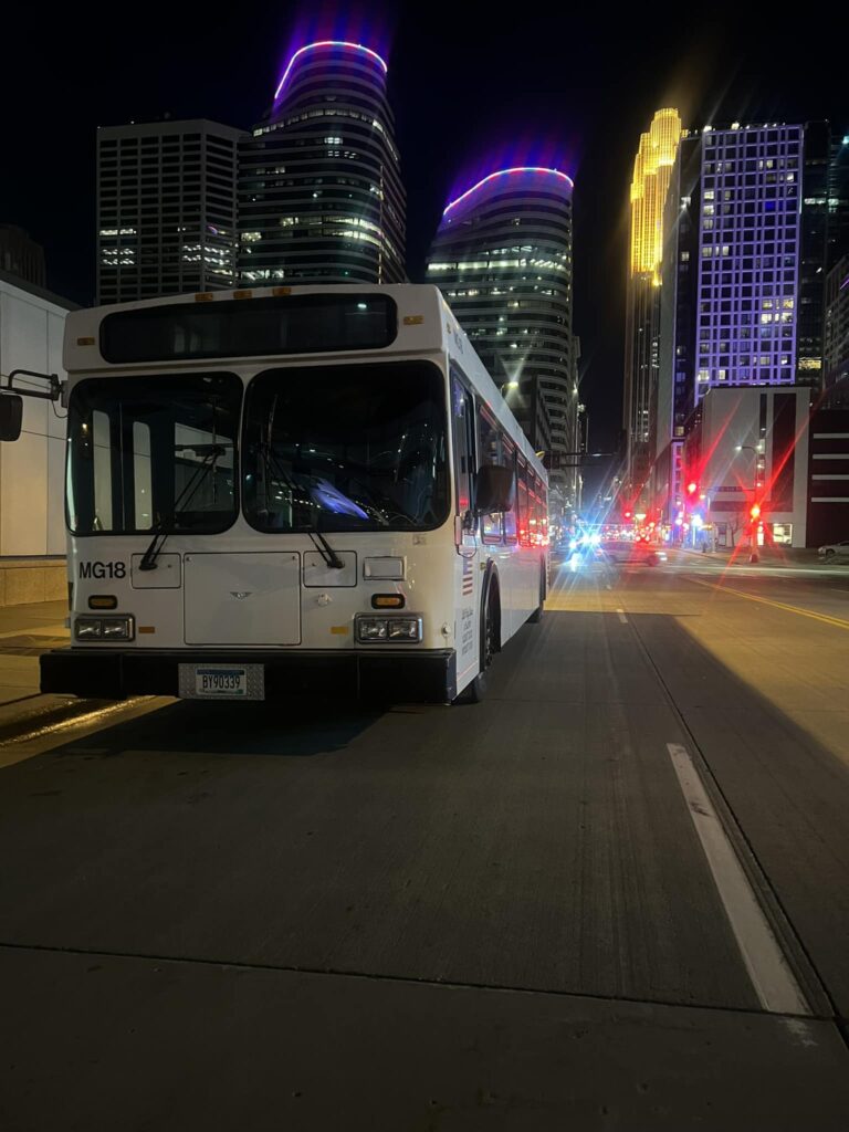 party bus rental in front of Minneapolis skyline