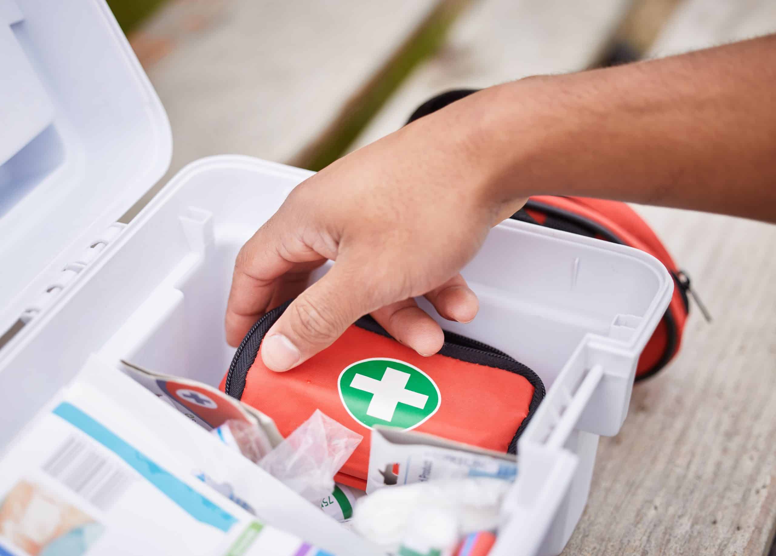licensed party bus company driver reaching into a first aid kit stored on a party bus, highlighting travel safety and emergency preparedness for party bus passengers
